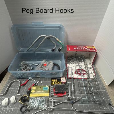 Sale Photo Thumbnail #122: Mixed metal hooks, locks, and hangers for pegboards and storage organization.