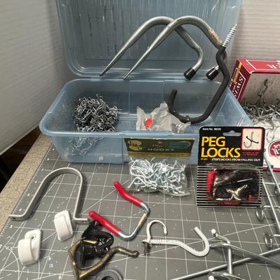 Sale Photo Thumbnail #123: Mixed metal hooks, locks, and hangers for pegboards and storage organization.