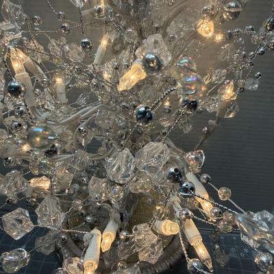 Sale Photo Thumbnail #145: Elegant decorative lighted tree with silver base and crystals.