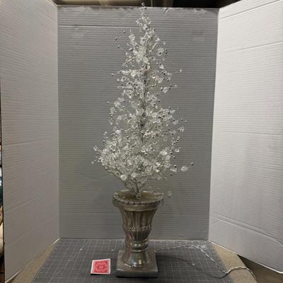 Sale Photo Thumbnail #146: Elegant decorative lighted tree with silver base and crystals.