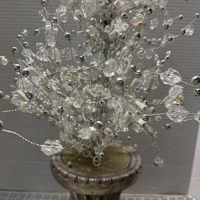 Sale Photo Thumbnail #144: Elegant decorative lighted tree with silver base and crystals.