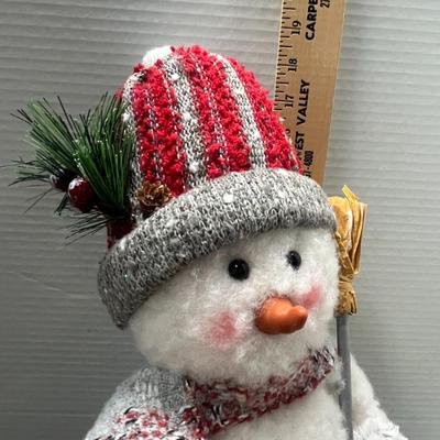 Sale Photo Thumbnail #319: Plaid hat, scarf, mittens, holds gold stick.