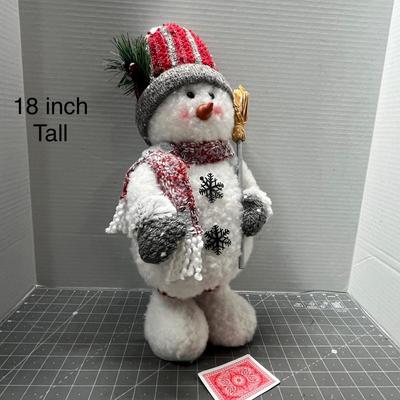 Sale Photo Thumbnail #318: Plaid hat, scarf, mittens, holds gold stick.