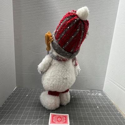 Sale Photo Thumbnail #320: Plaid hat, scarf, mittens, holds gold stick.