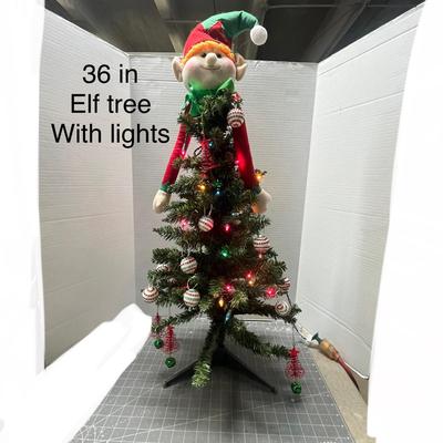 Sale Photo Thumbnail #366: Red/green elf topper, ornaments, multicolor lights, tripod base.