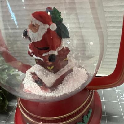 Sale Photo Thumbnail #411: Red lantern with Santa, glass candle holder, pine, berries.