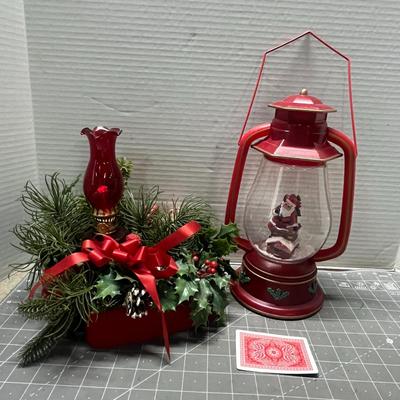 Sale Photo Thumbnail #410: Red lantern with Santa, glass candle holder, pine, berries.