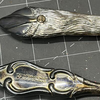 Sale Photo Thumbnail #467: Ornate handles, marked “International Silver Company.”