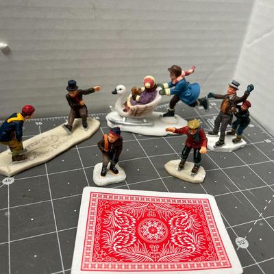 Sale Photo Thumbnail #607: People skating, sledding, dancing, singing, trees, ice patches.