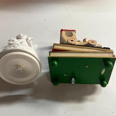 Sale Photo Thumbnail #637: Porcelain angel, wooden train music box on red-green base.