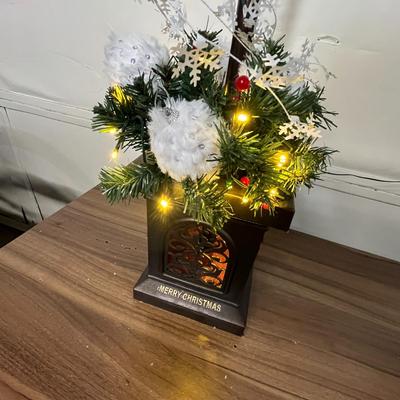 Sale Photo Thumbnail #702: Black lamp post, glowing lantern, snowy top, festive decorated base.