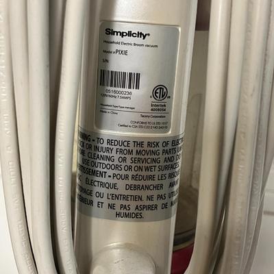 Sale Photo Thumbnail #765: Compact electric broom vacuum, 120V, includes owner’s manual.