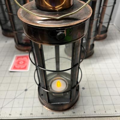 Sale Photo Thumbnail #954: Includes tealights, glass body, metal frame, rustic bronze finish.