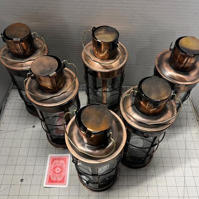 Sale Photo Thumbnail #950: Includes tealights, glass body, metal frame, rustic bronze finish.