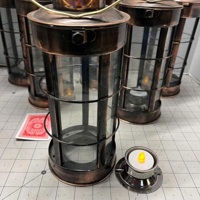 Sale Photo Thumbnail #953: Includes tealights, glass body, metal frame, rustic bronze finish.