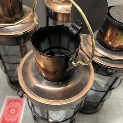 Sale Photo Thumbnail #952: Includes tealights, glass body, metal frame, rustic bronze finish.