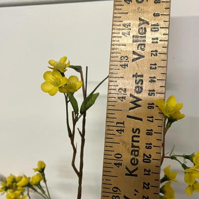 Sale Photo Thumbnail #968: Tall white vase, spring florals, yellow blossoms, green leaves, indoor decor.