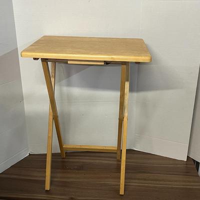 Sale Photo Thumbnail #1032: Portable rectangular table with support bar, light wood finish, compact.