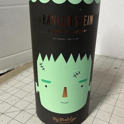 Sale Photo Thumbnail #1083: 20 1/4 × 20 inch puzzle, green monster design, round container