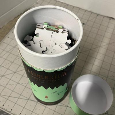 Sale Photo Thumbnail #1084: 20 1/4 × 20 inch puzzle, green monster design, round container