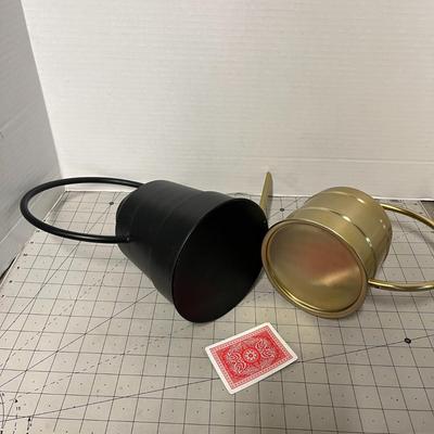 Sale Photo Thumbnail #1112: Two cans, matte black and shiny gold; different sizes, metal.