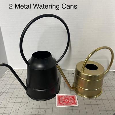 Sale Photo Thumbnail #1111: Two cans, matte black and shiny gold; different sizes, metal.