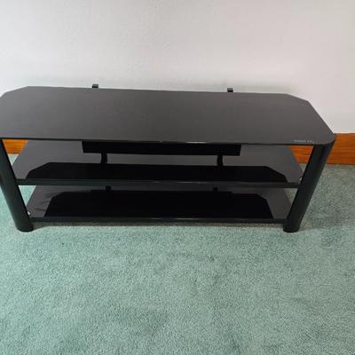 Innov-ex black tempered glass TV stand.