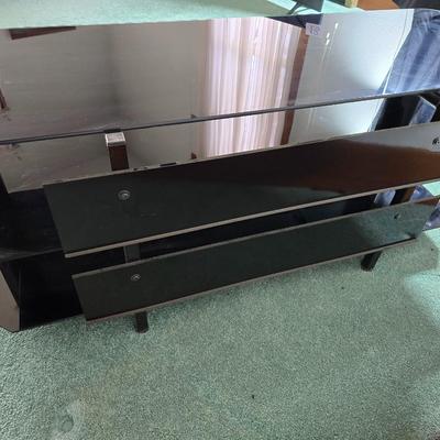 Innov-ex black tempered glass TV stand.
