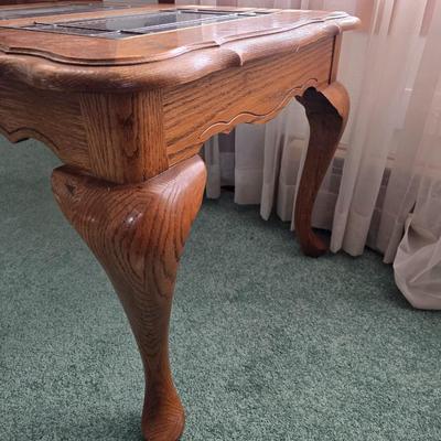 Vintage solid oak coffee table featuring a decorative, beveled, and leaded glass top insert and elegant curved or "ball and...