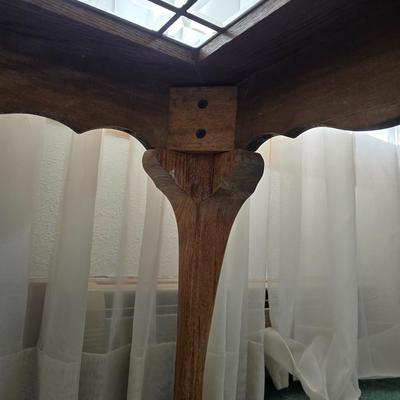 Vintage solid oak coffee table featuring a decorative, beveled, and leaded glass top insert and elegant curved or "ball and...