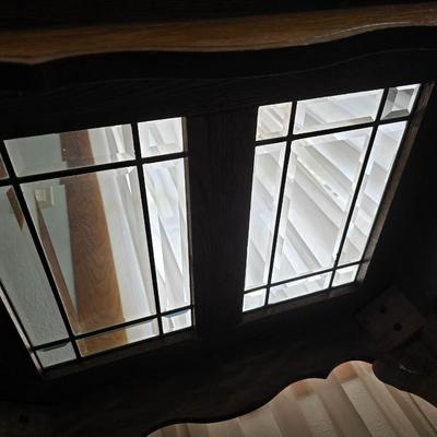 Vintage solid oak coffee table featuring a decorative, beveled, and leaded glass top insert and elegant curved or "ball and...