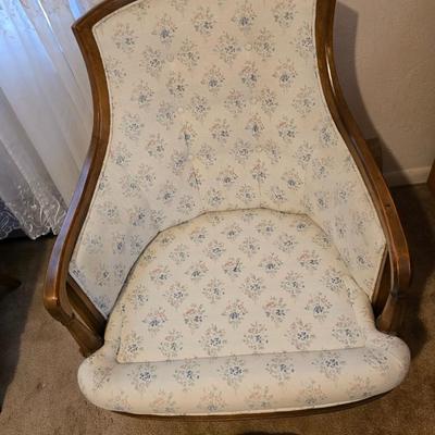 late 1960s armchair with a walnut frame and light-colored floral upholstery.