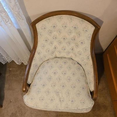 late 1960s armchair with a walnut frame and light-colored floral upholstery.