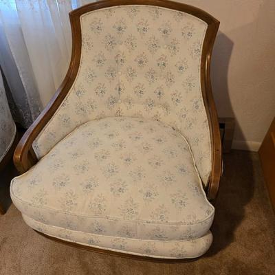 late 1960s armchair with a walnut frame and light-colored floral upholstery.