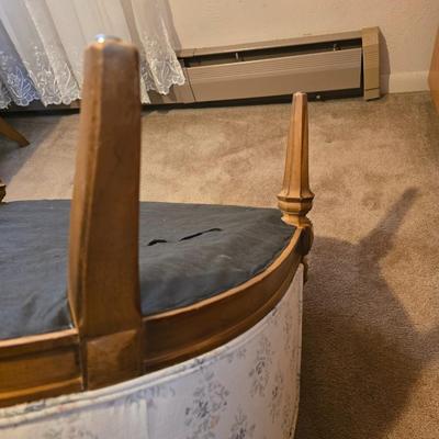 late 1960s armchair with a walnut frame and light-colored floral upholstery.