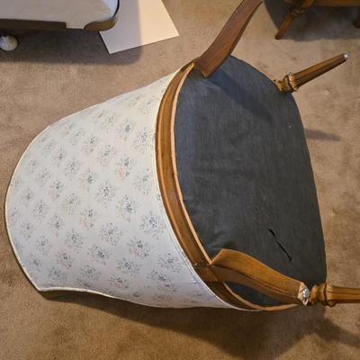 late 1960s armchair with a walnut frame and light-colored floral upholstery.