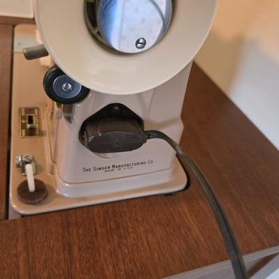 Singer 401A sewing machine, a vintage model known for its durability and functionality with sewing cabinet and some accessories