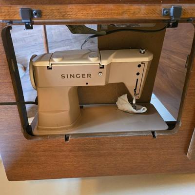 Singer 401A sewing machine, a vintage model known for its durability and functionality with sewing cabinet and some accessories
