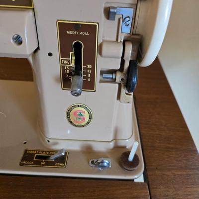 Singer 401A sewing machine, a vintage model known for its durability and functionality with sewing cabinet and some accessories