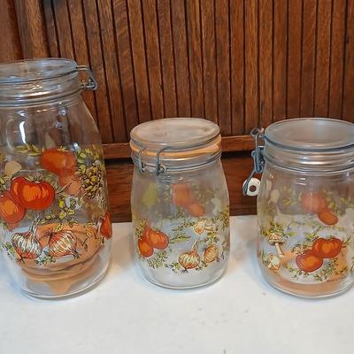 vintage glass canisters with a "Spice of Life" pattern, made by ARC in France. 1 & 2 Liter Jars with a trivet
