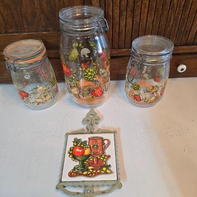 vintage glass canisters with a "Spice of Life" pattern, made by ARC in France. 1 & 2 Liter Jars with a trivet