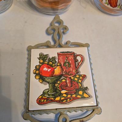 vintage glass canisters with a "Spice of Life" pattern, made by ARC in France. 1 & 2 Liter Jars with a trivet