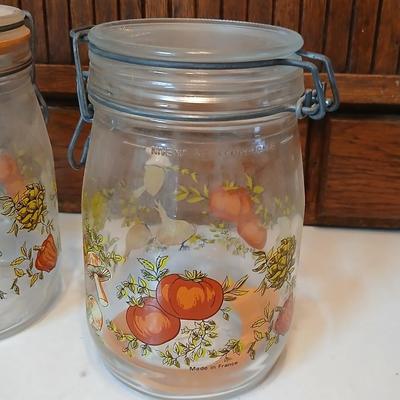 vintage glass canisters with a "Spice of Life" pattern, made by ARC in France. 1 & 2 Liter Jars with a trivet