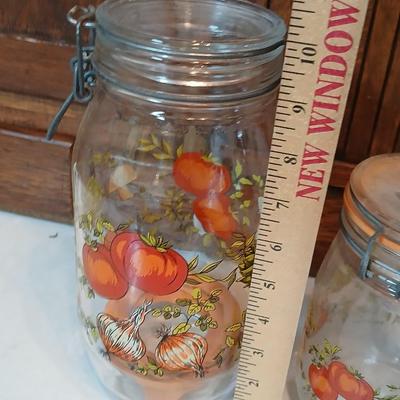 vintage glass canisters with a "Spice of Life" pattern, made by ARC in France. 1 & 2 Liter Jars with a trivet