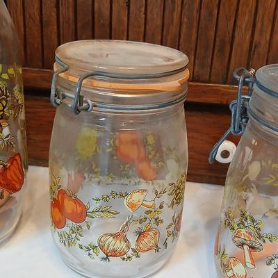 vintage glass canisters with a "Spice of Life" pattern, made by ARC in France. 1 & 2 Liter Jars with a trivet