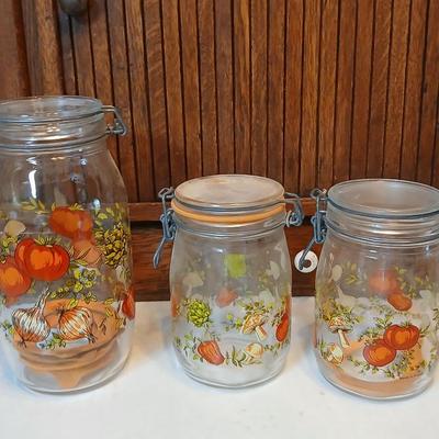 vintage glass canisters with a "Spice of Life" pattern, made by ARC in France. 1 & 2 Liter Jars with a trivet