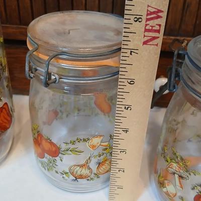 vintage glass canisters with a "Spice of Life" pattern, made by ARC in France. 1 & 2 Liter Jars with a trivet