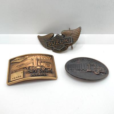 LOT 65: Collection of Vintage Belt Buckles - Keep on Truckin, Suzuki Motor Cycles and Merico Safe Driver Award