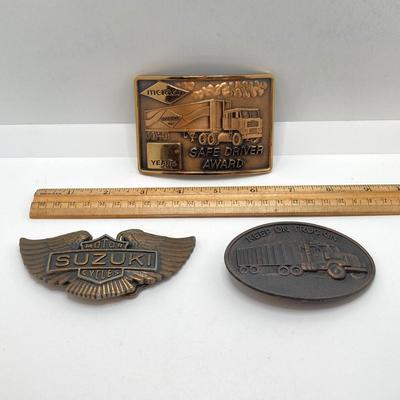 LOT 65: Collection of Vintage Belt Buckles - Keep on Truckin, Suzuki Motor Cycles and Merico Safe Driver Award