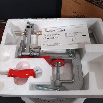 LOT 165: The Pampered Chef Apple Peeler and Prep Bowls with Nantucket Pie Plate, Fire King Measuring Cup & More